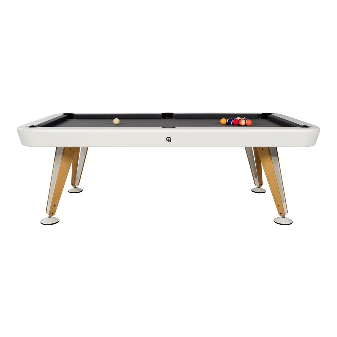 Modern white pool table with black felt surface and natural wood legs; vibrant colored balls add a playful touch.