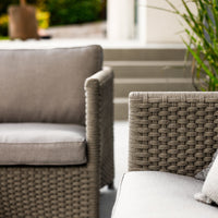 Stylish outdoor seating with a beige woven pattern and soft gray cushions, perfect for modern patios and gardens.