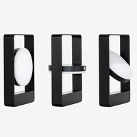 Modern black and white geometric lamps showcasing smooth shapes and contrasting patterns. Ideal for contemporary decor.