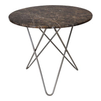 Round marble table with dark brown surface and white veining, supported by a sleek, geometric metal base.