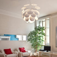 Elegant white pendant light with petal-like design, illuminating a bright and contemporary living room.