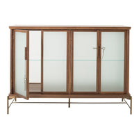 Wooden cabinet with a natural finish, featuring sleek glass doors and a minimalist design. Earthy tones and clean lines.