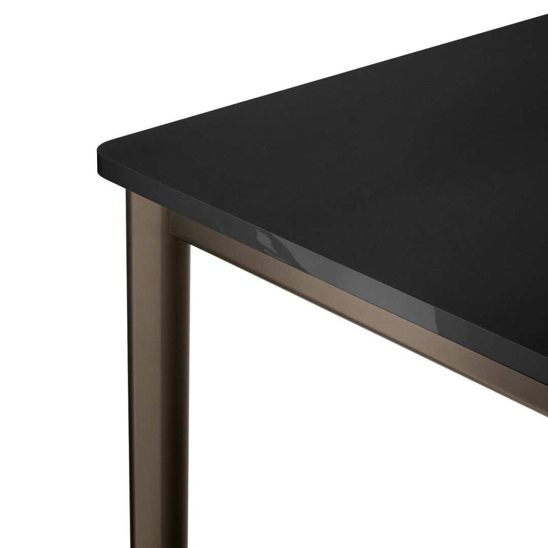 Black tabletop with smooth finish and bronze metal legs, offering a modern and sleek design. Ideal for contemporary spaces.