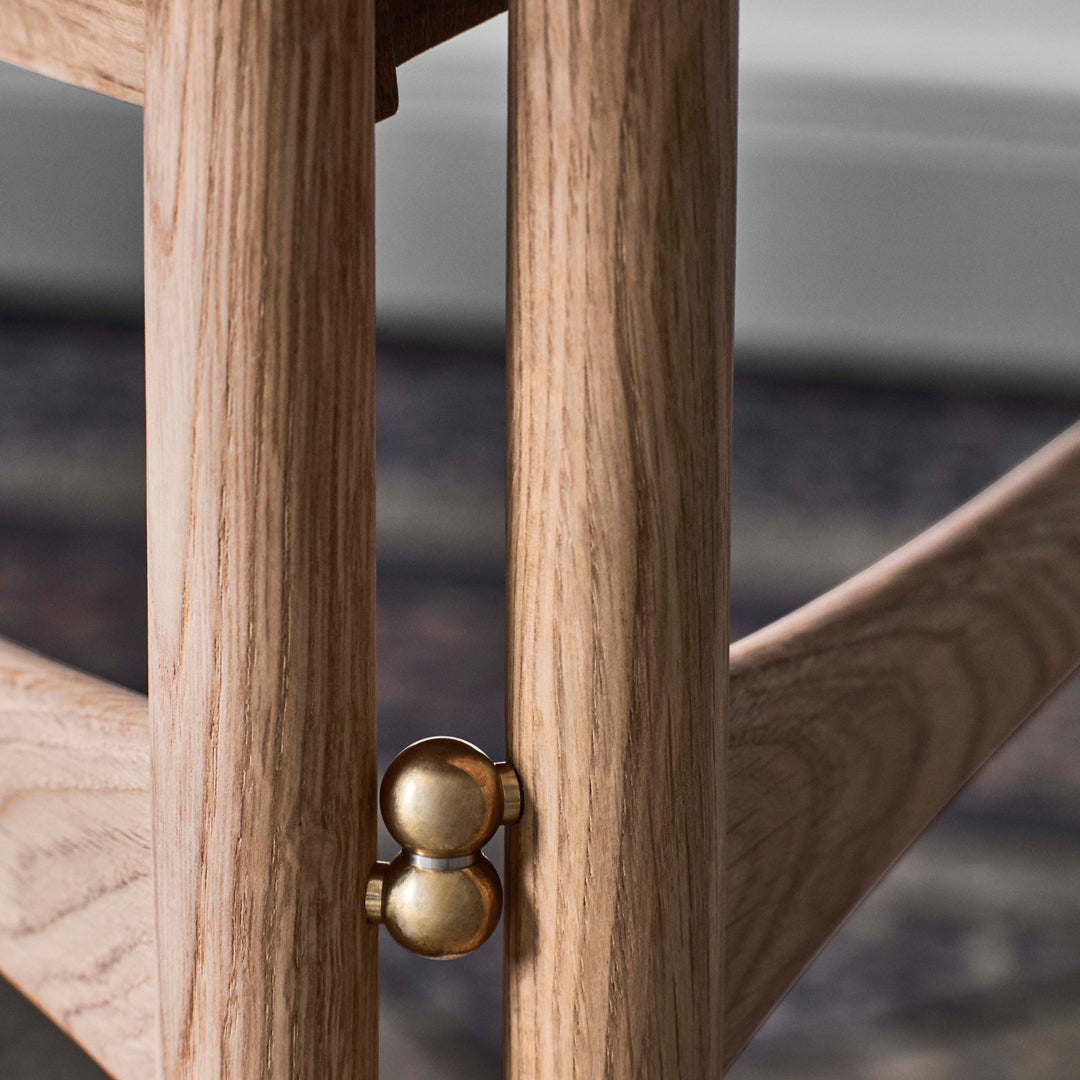 Light oak wood with subtle grain patterns, accented by a shiny gold connector detail.