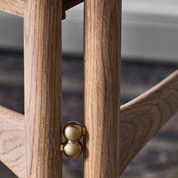 Light oak wood with subtle grain patterns, accented by a shiny gold connector detail.