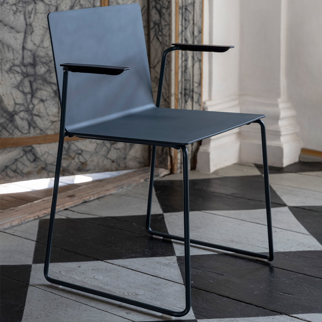 Stylish gray chair with minimalist design, featuring a sleek matte finish and black metal frame accents.