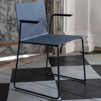 Stylish gray chair with minimalist design, featuring a sleek matte finish and black metal frame accents.