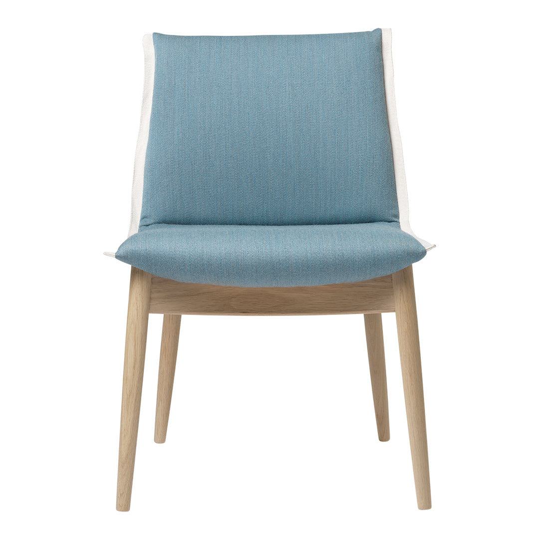 Light blue upholstered chair with a textured fabric and natural wooden legs. Modern design with a minimalist aesthetic.