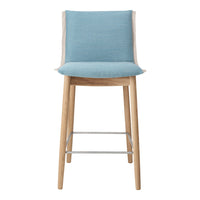 Blue upholstered bar stool with light wood legs and a simple, modern design. Ideal for contemporary decor.