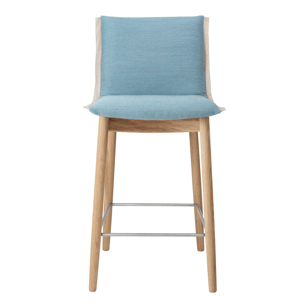 Light blue upholstered bar stool with wood legs and neutral beige accents, featuring a sleek and modern design.