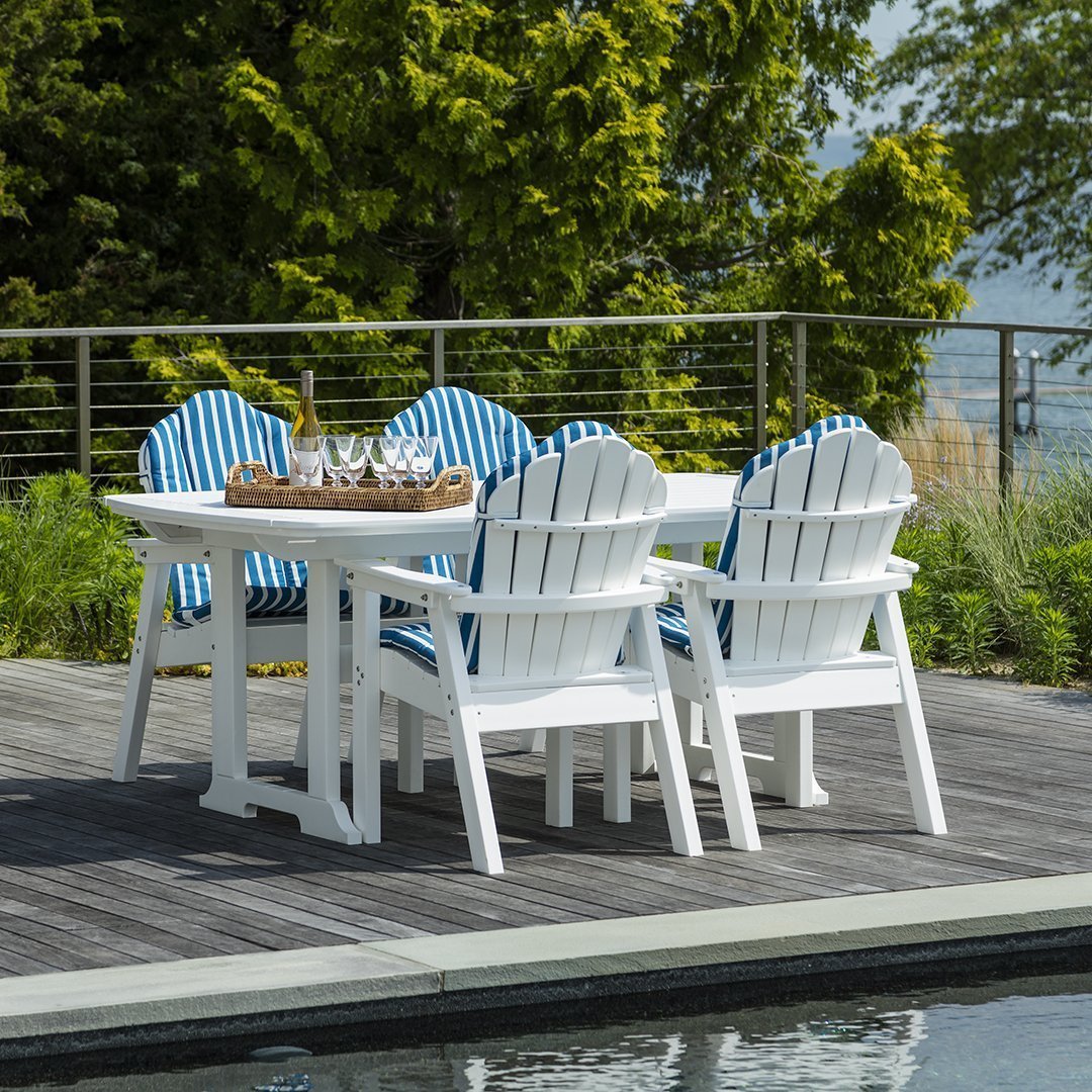 White outdoor dining set with blue striped cushions, perfect for summer gatherings.
