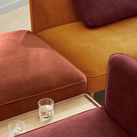 Multicolored sofa featuring warm shades of orange, burgundy, and mustard with varied textures and clean lines.