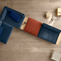 Three-piece sofa in deep navy, rich orange, and soft blue with a smooth fabric texture on a light wooden floor.
