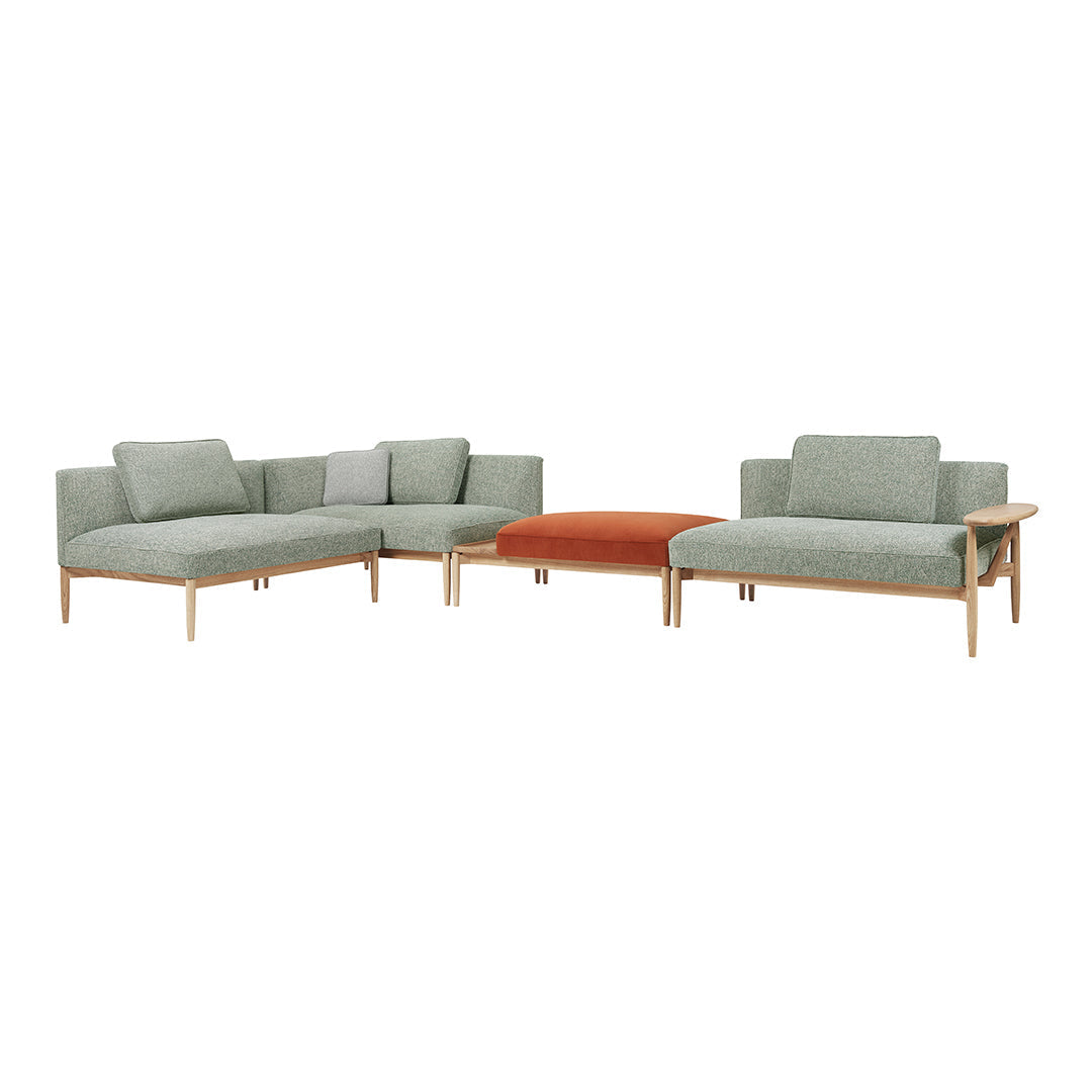 Light green fabric sofa set with a contrasting orange cushion, featuring clean lines and modern wooden legs.