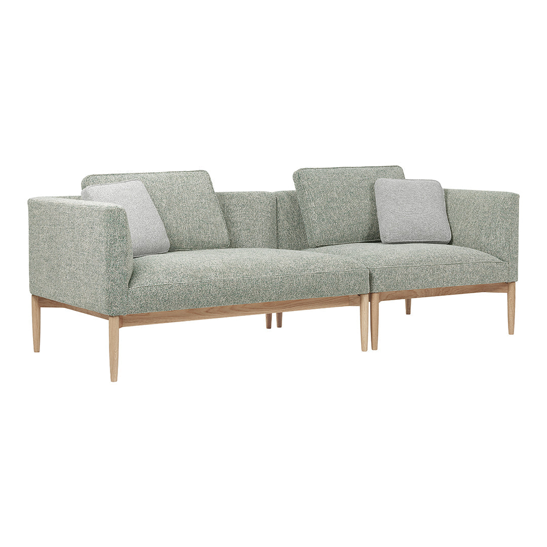 Light green textured upholstery with contrasting gray cushions and natural wood legs. Modern and stylish design.