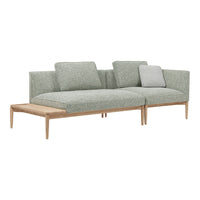 Green fabric sectional sofa with minimalist design and light wooden legs, featuring muted textures and clean lines.