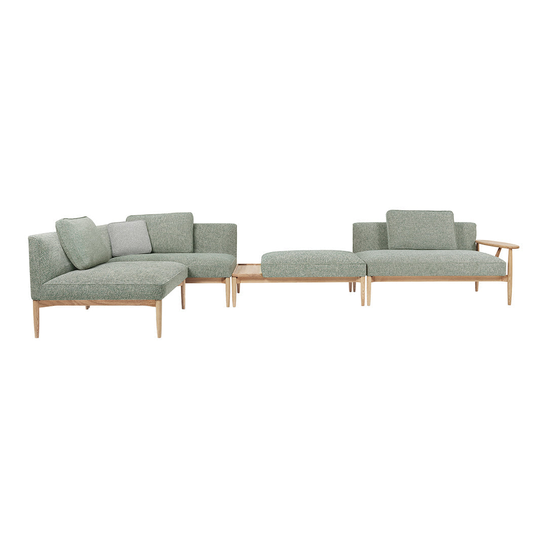 Light green modern sofa set with wooden legs and minimalist design featuring solid and subtle patterned cushions.