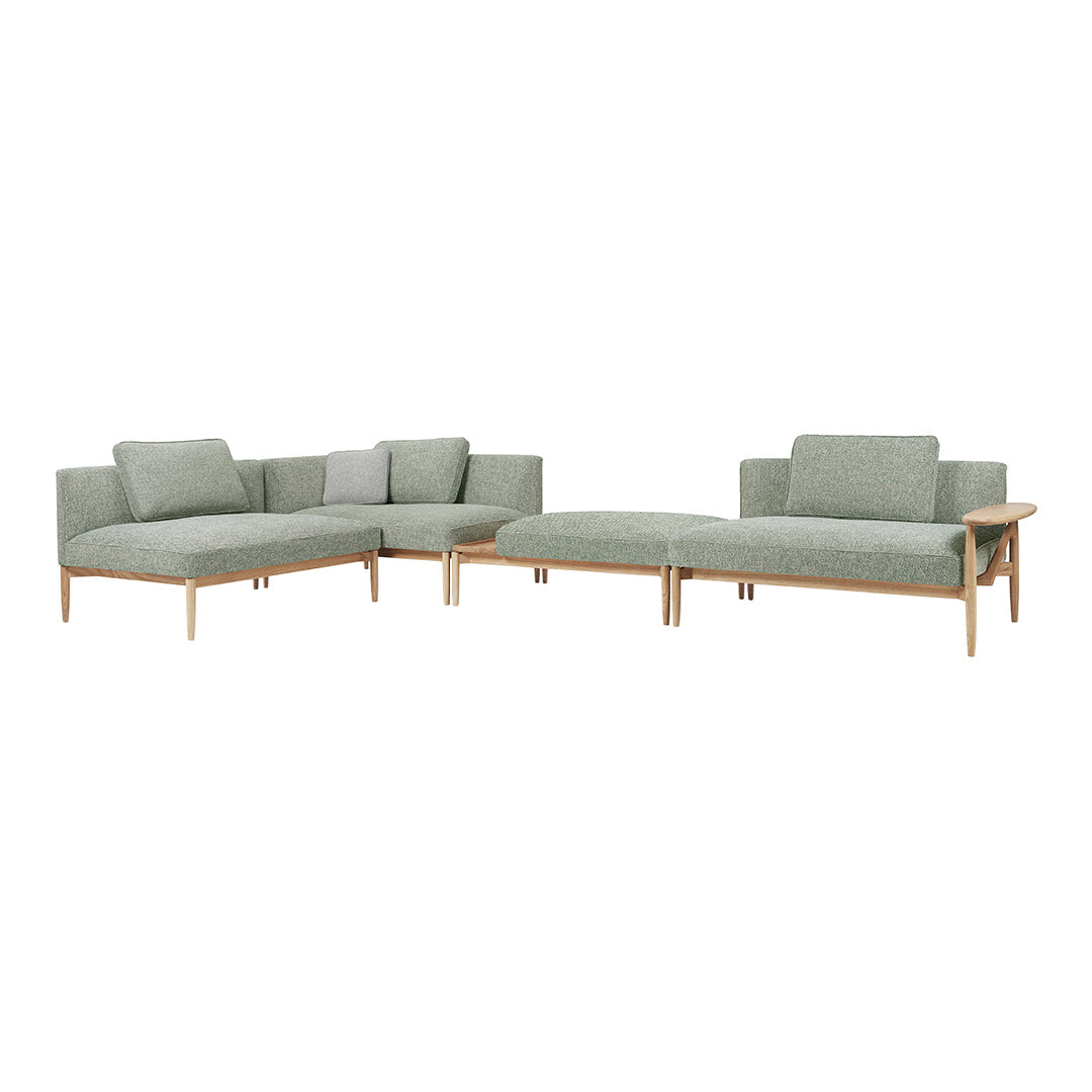 Light green sectional sofa with a modern design and subtle textural pattern on the upholstery.