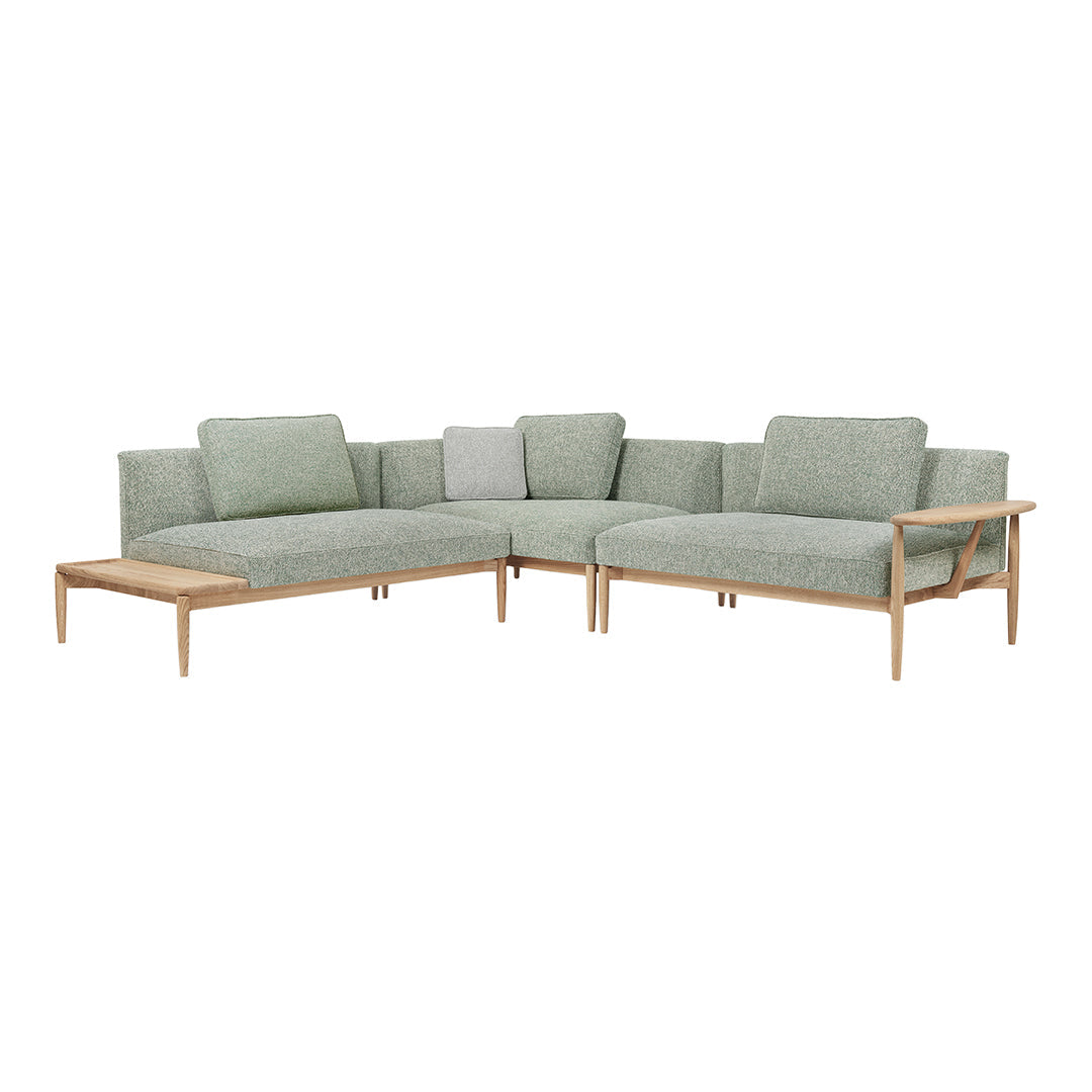 Light green textured fabric sectional sofa with wooden legs, featuring a minimalist design. Perfect for modern interiors.