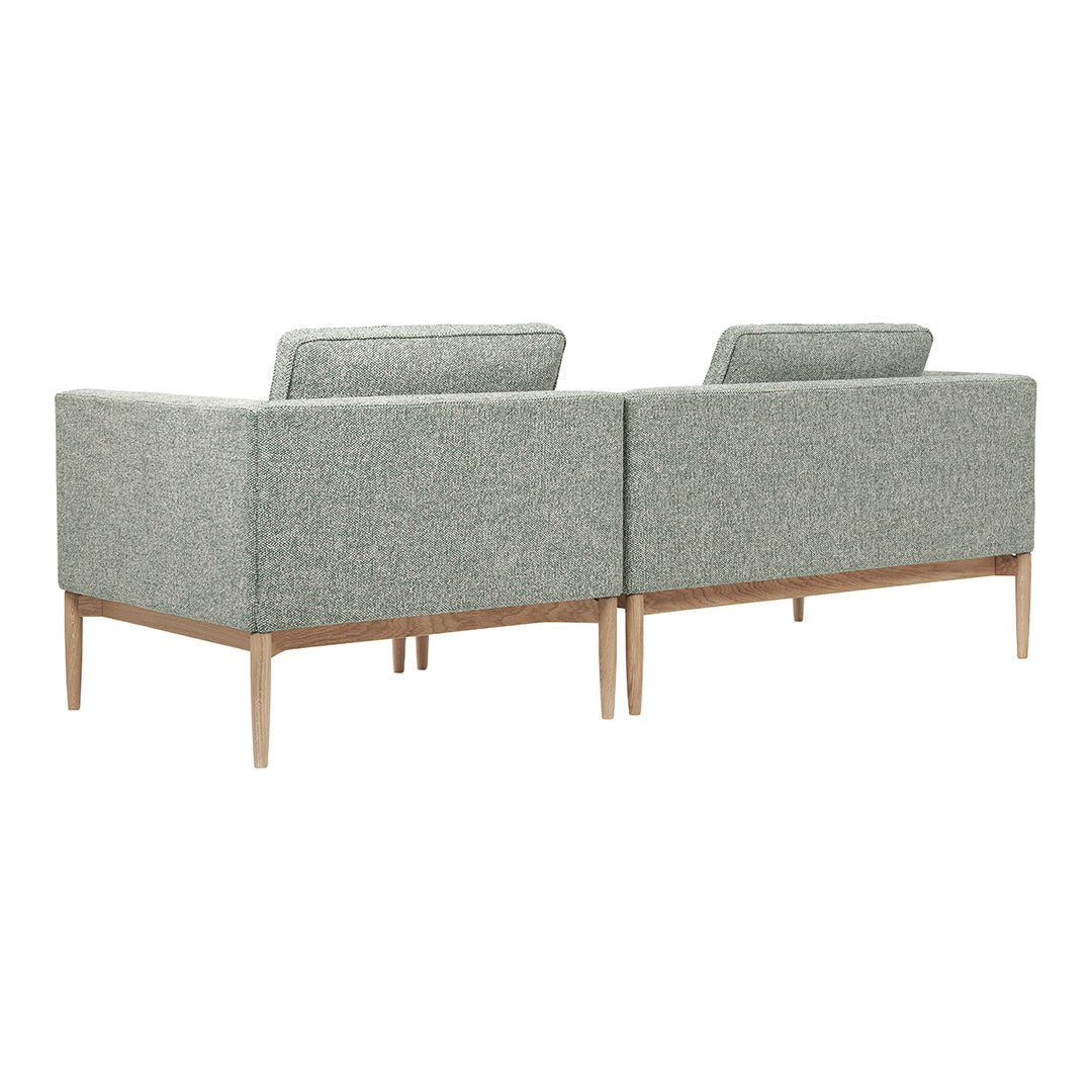 Light green modern sofa with subtle textured pattern and natural wood legs, perfect for contemporary living spaces.