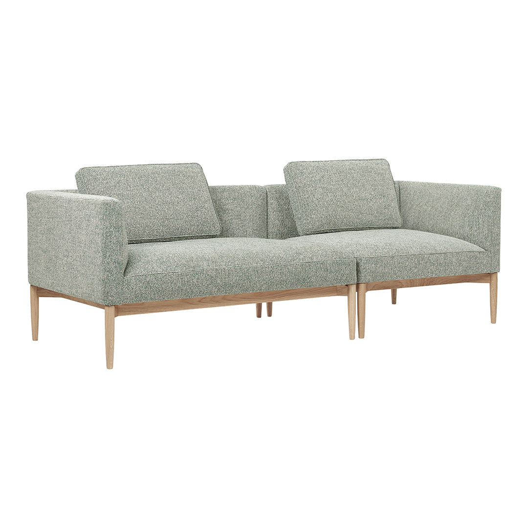 Light grey fabric sofa with minimalistic design and wooden legs, offering a modern touch to any living space.