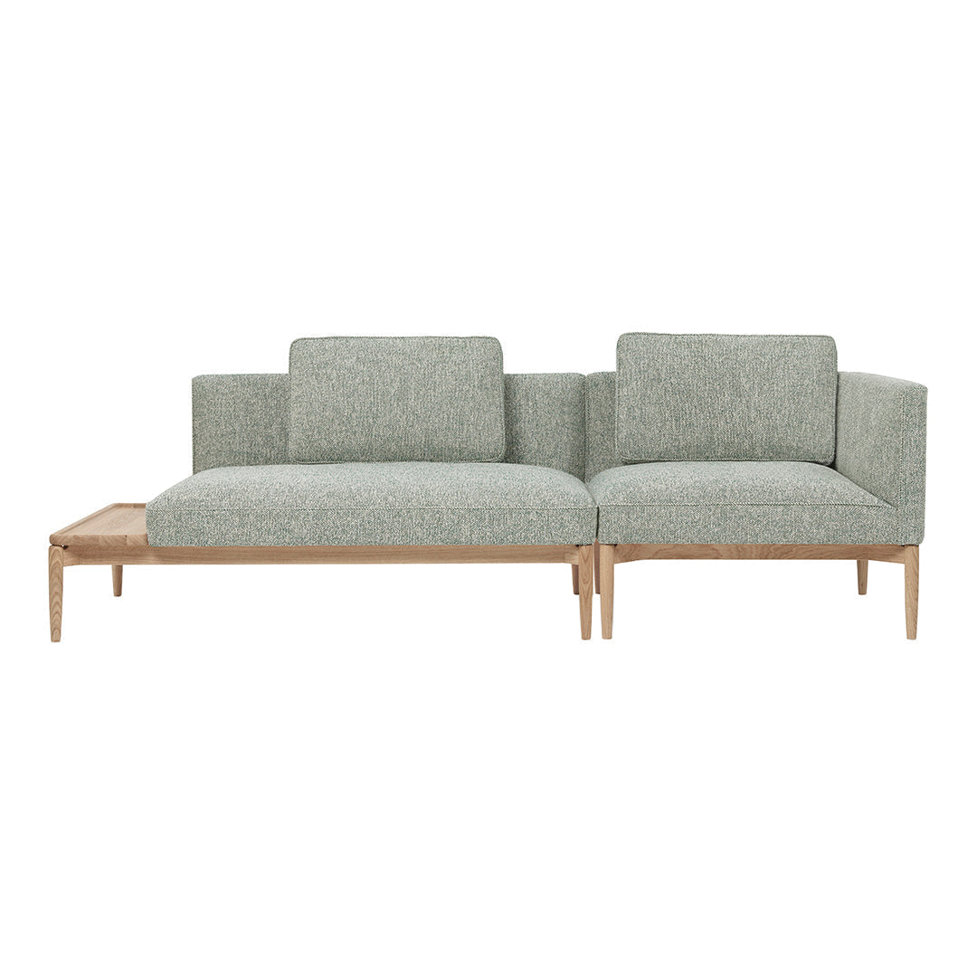 Light green textured fabric sofa with wooden legs and minimalistic design, ideal for modern interiors.