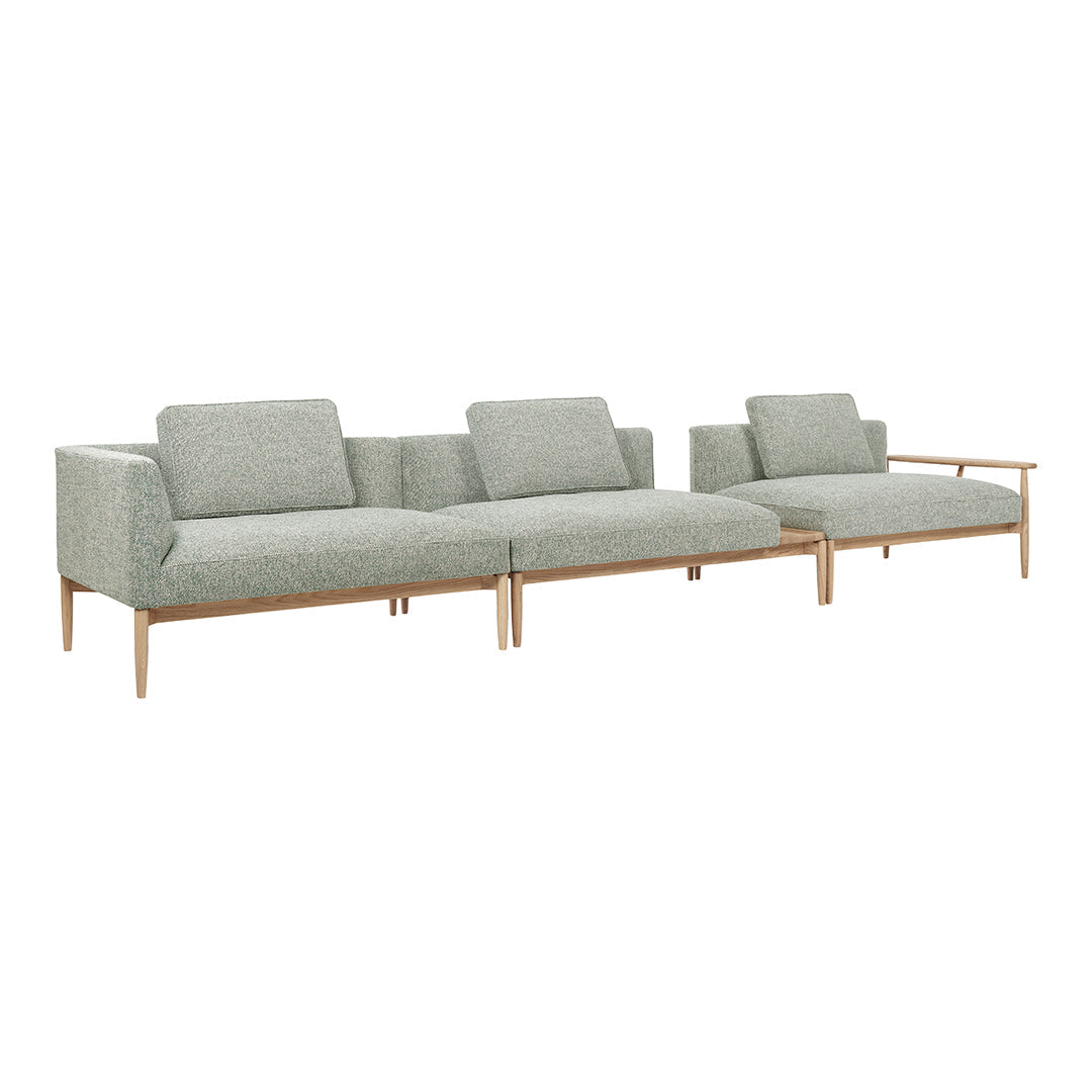 Light green fabric sectional sofa with a subtle texture and wooden legs, perfect for modern living spaces.