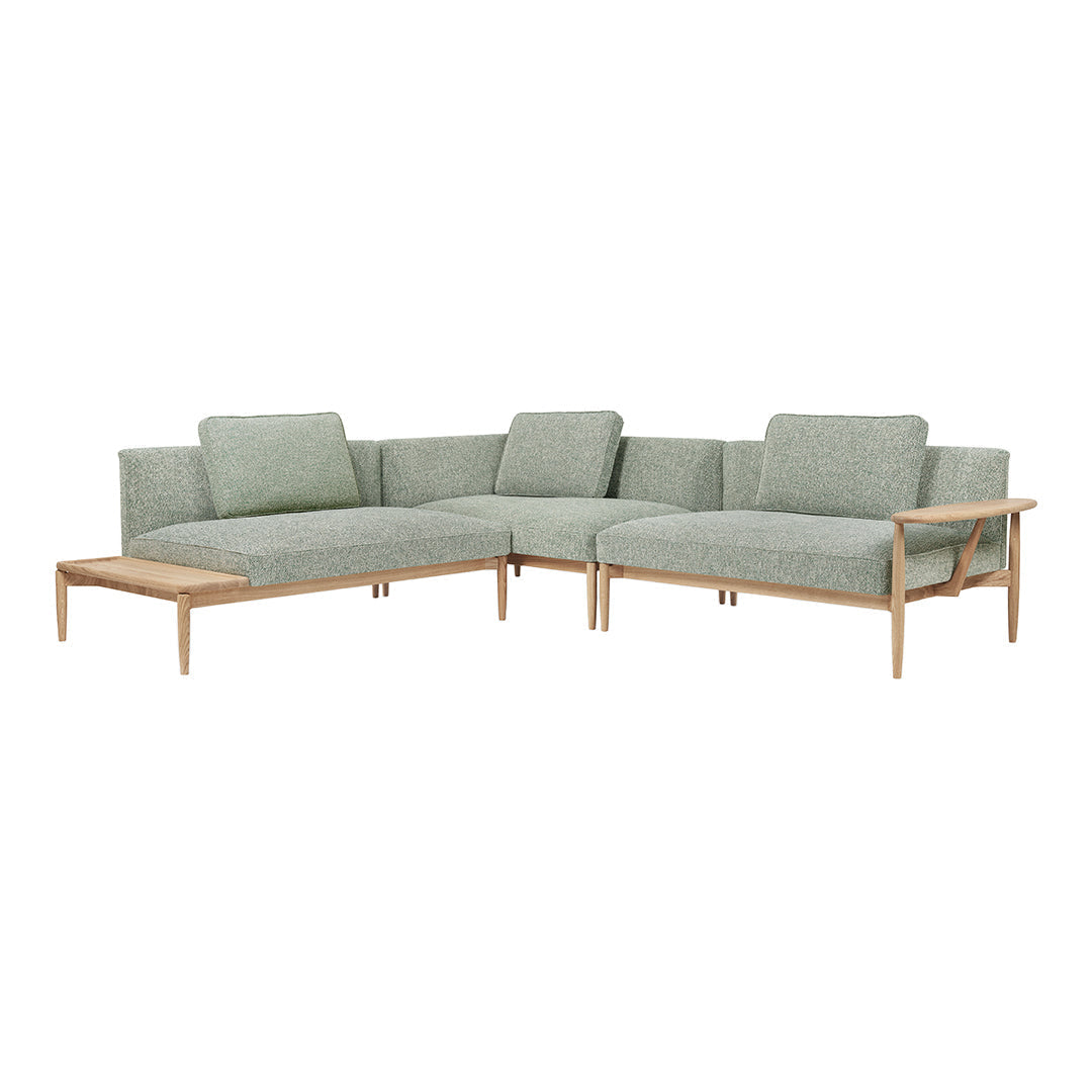  Light green fabric sectional sofa with a minimalist design and wooden frame, perfect for modern interiors.
