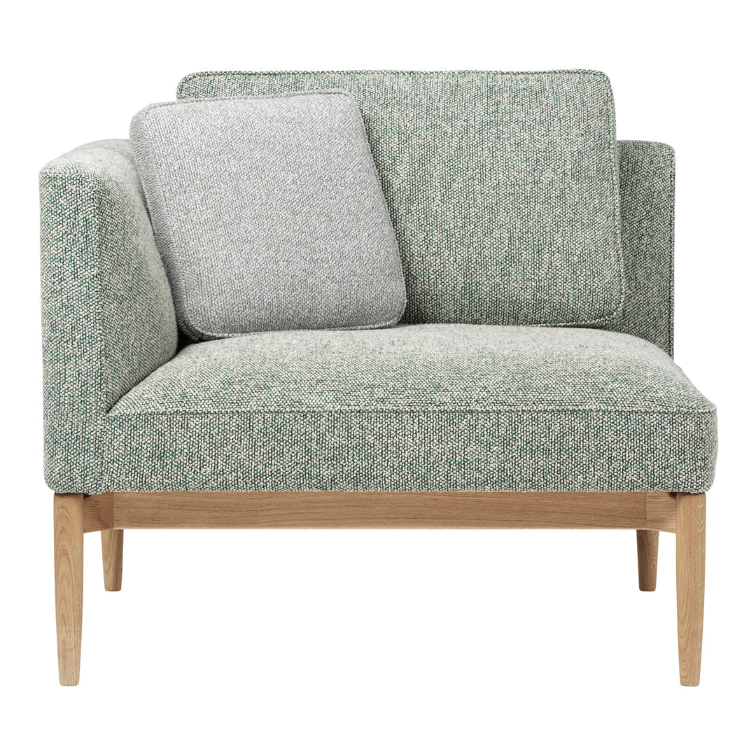 Light green textured upholstery with a gray accent pillow and natural wood legs, perfect for stylish living spaces.