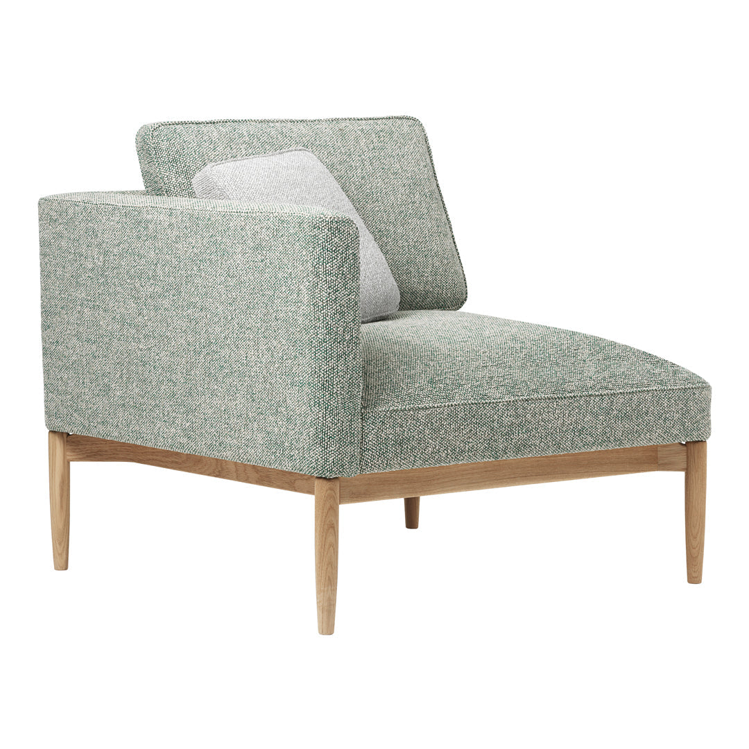 Light green textured upholstery with a contrasting white accent pillow, featuring sleek wooden legs.