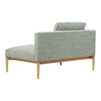 Light green upholstered chaise lounge with subtle textured pattern and natural wood legs. Elegant and modern design.