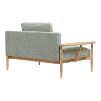 Green patterned upholstery on a mid-century modern sofa with wooden frame and legs.