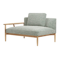 Mint green upholstered chair with a subtle floral pattern and light wood accents. Modern and stylish design.