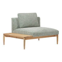 Light green textured fabric armchair with natural wood legs and a minimalist design.