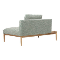 Light green textured upholstery with a subtle pattern, paired with a natural wood frame. Modern chaise lounge design.