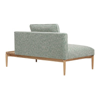 Light teal upholstered chaise lounge with textured pattern and natural wood legs. Elegant and modern design.