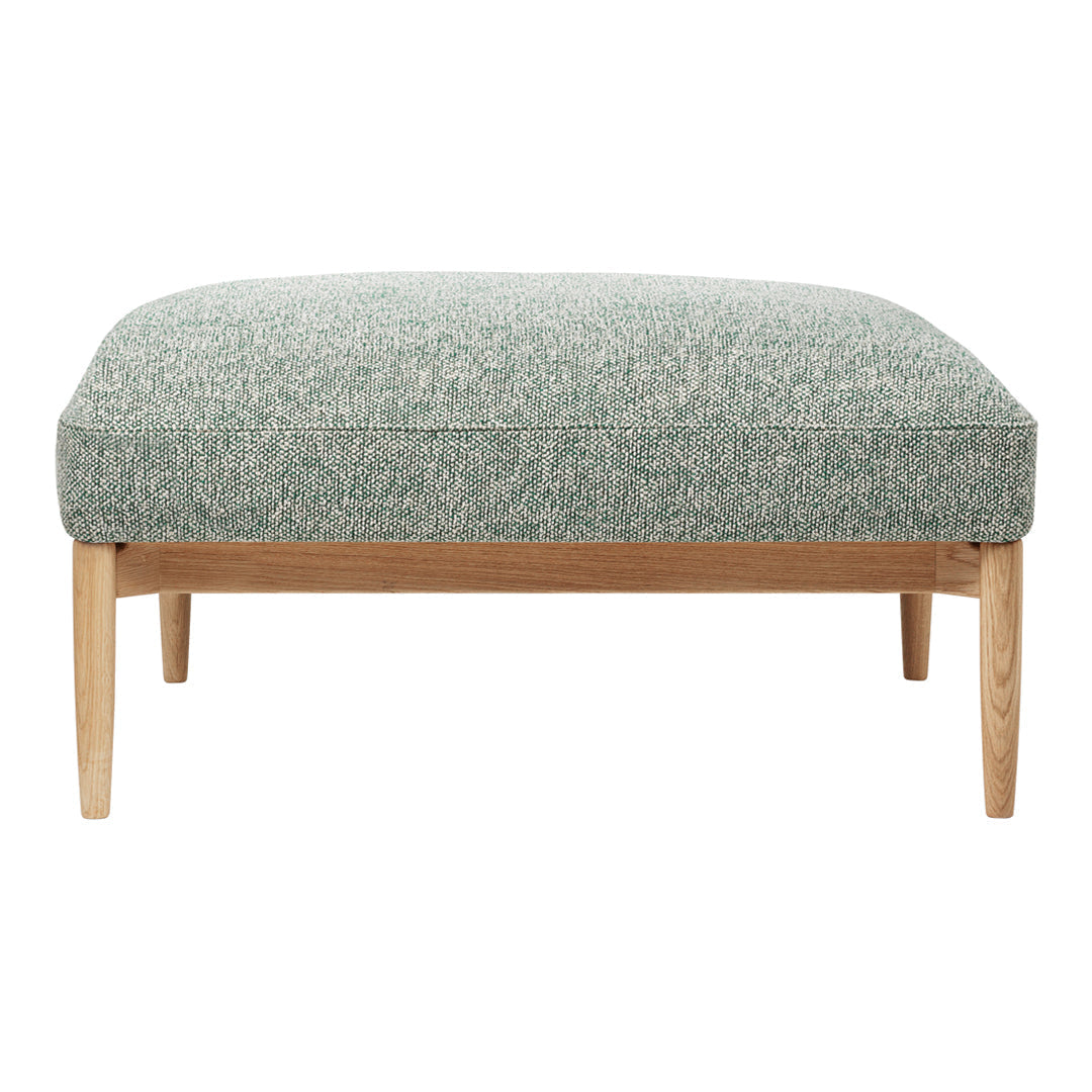 Green textured ottoman with a subtle pattern, featuring light wooden legs for a modern touch.