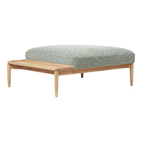 Light teal patterned cushion on a natural wood frame, offering a modern and cozy design. Perfect for minimalist decor.