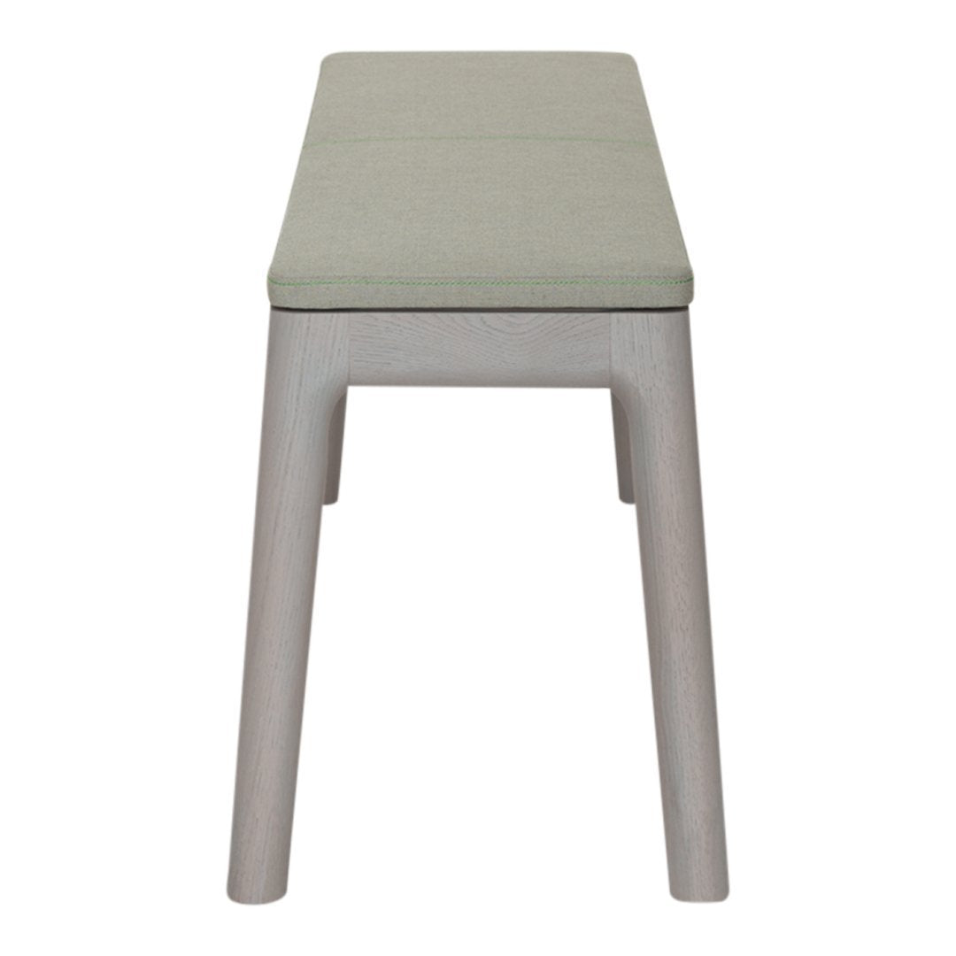 Light gray bench with a soft green cushion, featuring a simple, modern design and clean lines.