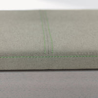 Light gray fabric with subtle texture and contrasting green stitching detail. Ideal for modern home decor.
