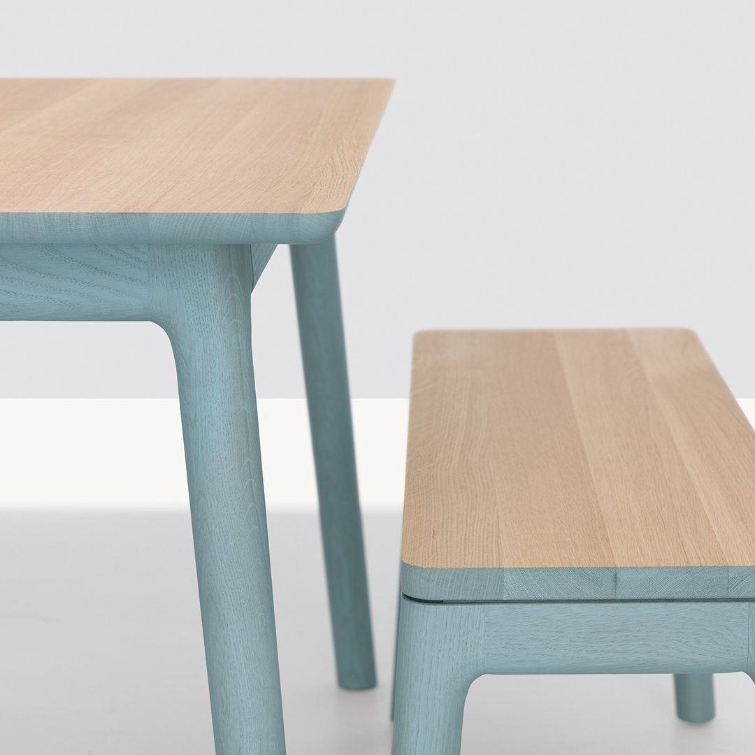 Light wood tabletop with soft blue legs, matching blue bench, modern minimalist design. Perfect for contemporary decor.