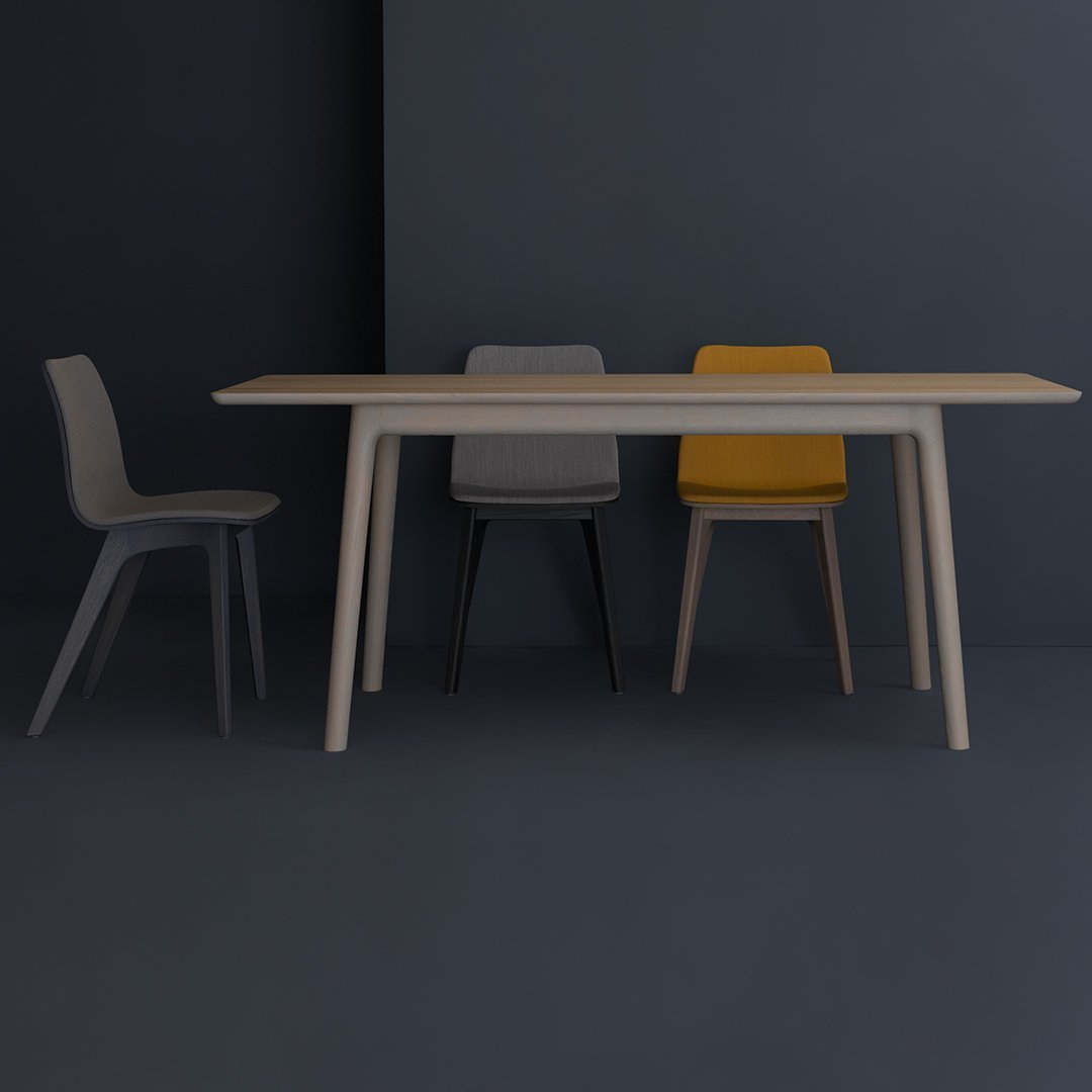 Modern dining table with a light wood finish, paired with sleek gray and yellow chairs against a dark background.