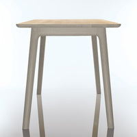 Light wood tabletop with a smooth finish, paired with sleek, neutral-colored legs for a modern look.