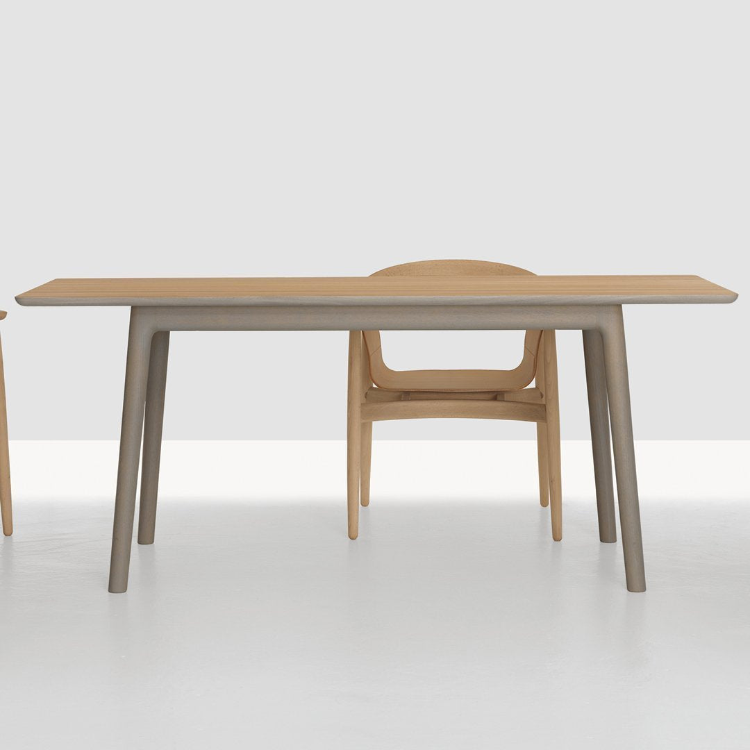 Natural wood table with a light tan finish and sleek gray legs, complemented by a matching chair design.