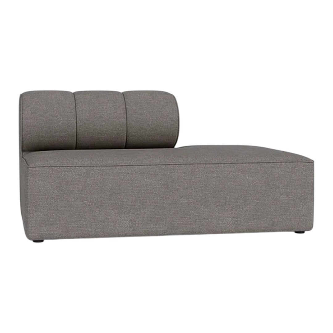 Grey fabric chaise lounge with a minimalist design and subtle tufted backrest. Smooth textured upholstery.