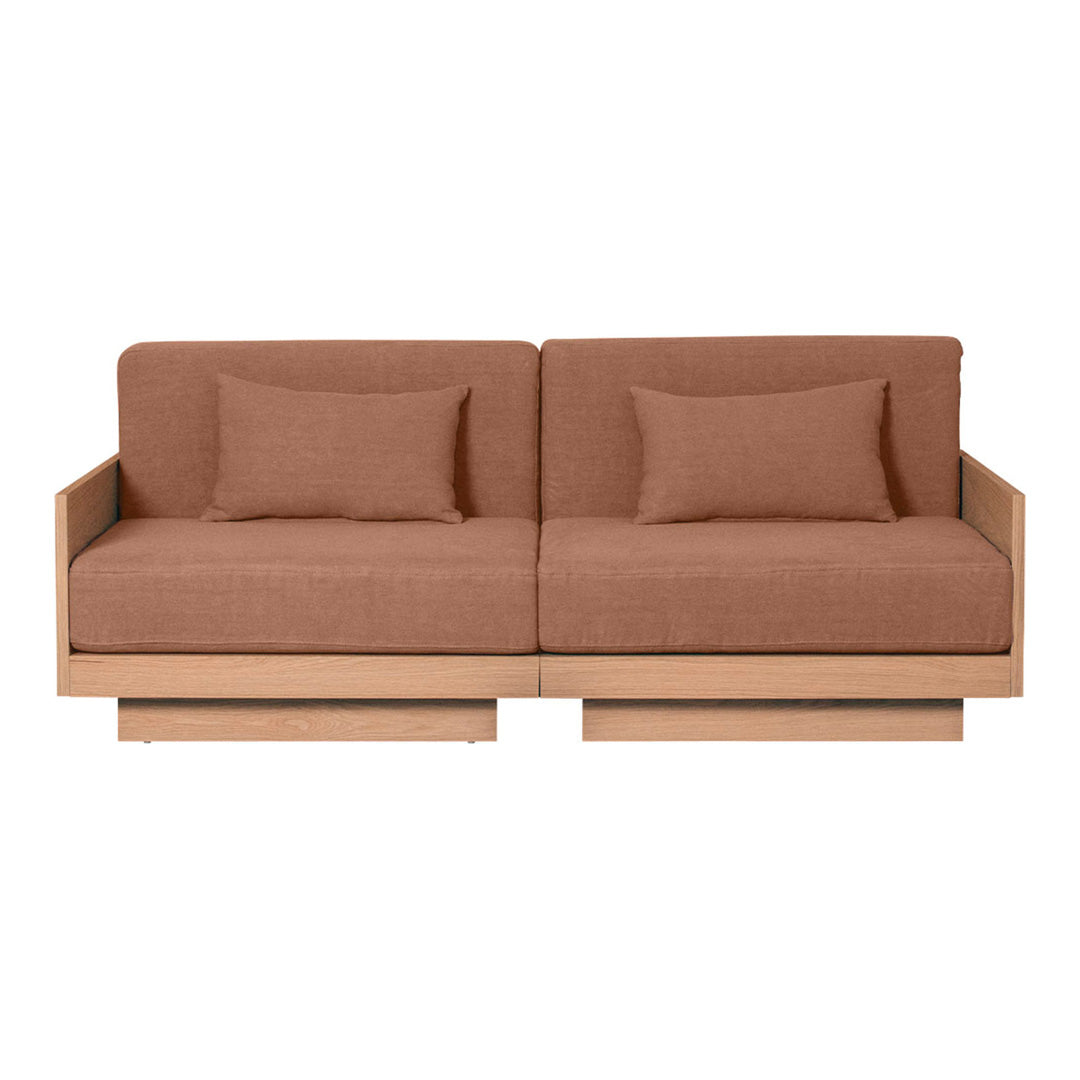 Brown upholstered sofa with a minimalist design and wooden base, featuring solid color cushions for a contemporary look.