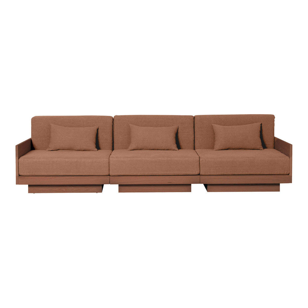 Three-seat sofa in warm brown fabric with subtle texture and matching pillows. Modern, minimalist design.