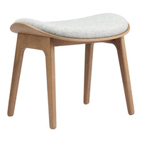 Light gray upholstered stool with a smooth, curved seat and natural wood legs, showcasing a minimalist design.