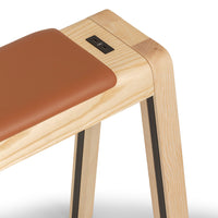Brown leather seat with natural wood frame and black accents, showcasing a modern, minimalist design.