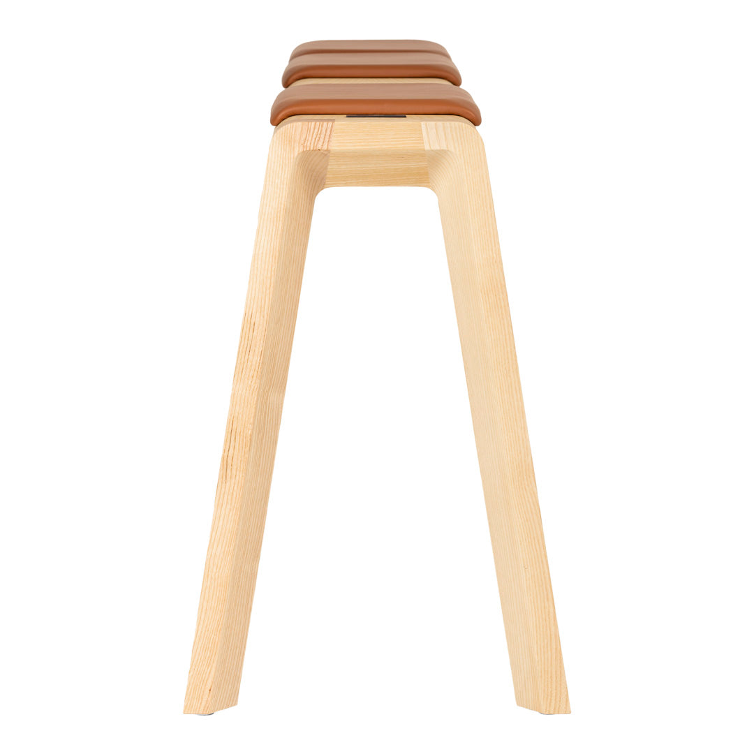 Light wood stool with three smooth, brown seats above a simple, sleek design.